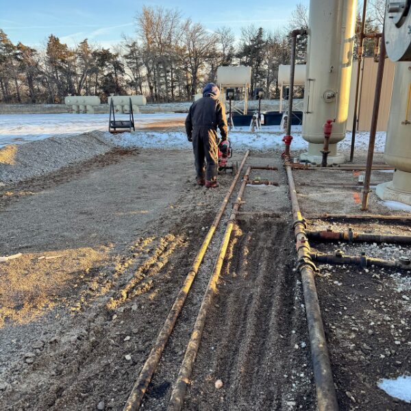 ACME employee hand tilling contaminated soil