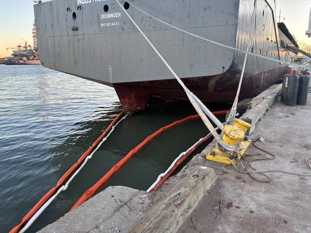 Sorbent boom and ACME's boom deployed around the ship to prevent oil from spreading 