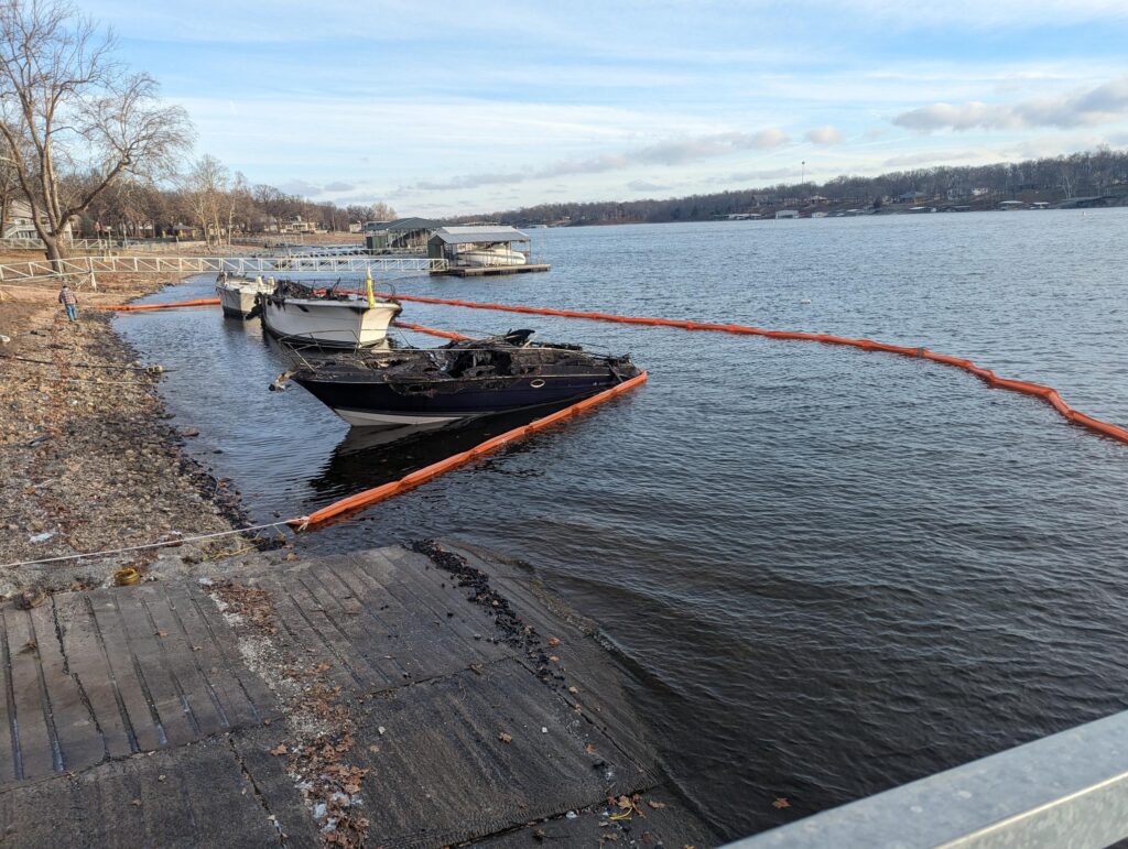 ACME's 18" Contractor Containment Boom deployed around a boat that had caught on fire to contain fuel, oil, and debris