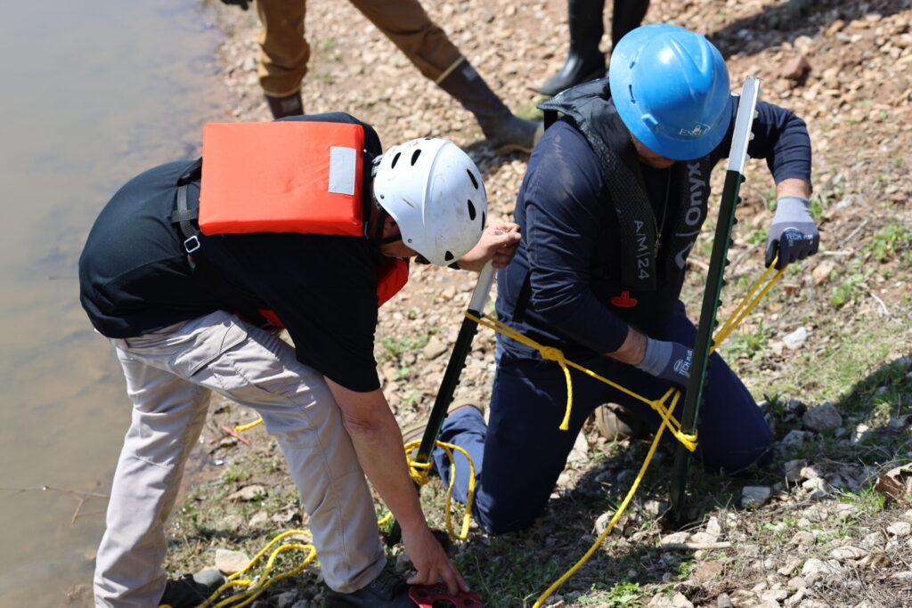 Students preparing the anchors for tie-off locations for the containment boom