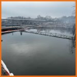 12" fastwater river and creek boom deployed around an area to protect boat slips from oil
