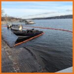 12" fastwater river and creek boom deployed around an area contaminated with oil