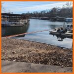 12" fastwater river and creek boom being deployed to prevent oil from spreading further