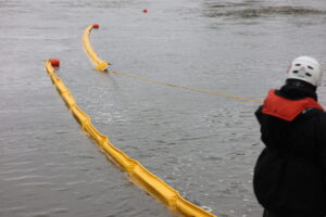 Both Sections of Containment Boom Deployed in a Cascading Pattern
