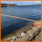 18" contractor boom deployed in a river to prevent the spread of hydrocarbons