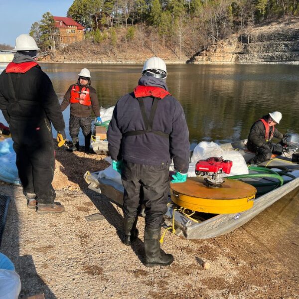 ACME workers loading boats with the necessary equipment to clean up the oil in the water