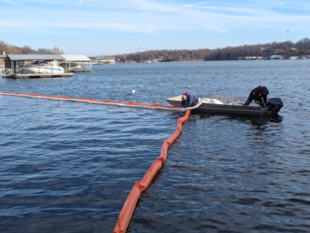 ACME employees deploying containment boom and absorbent boom to contain a fuel spill near boat slips