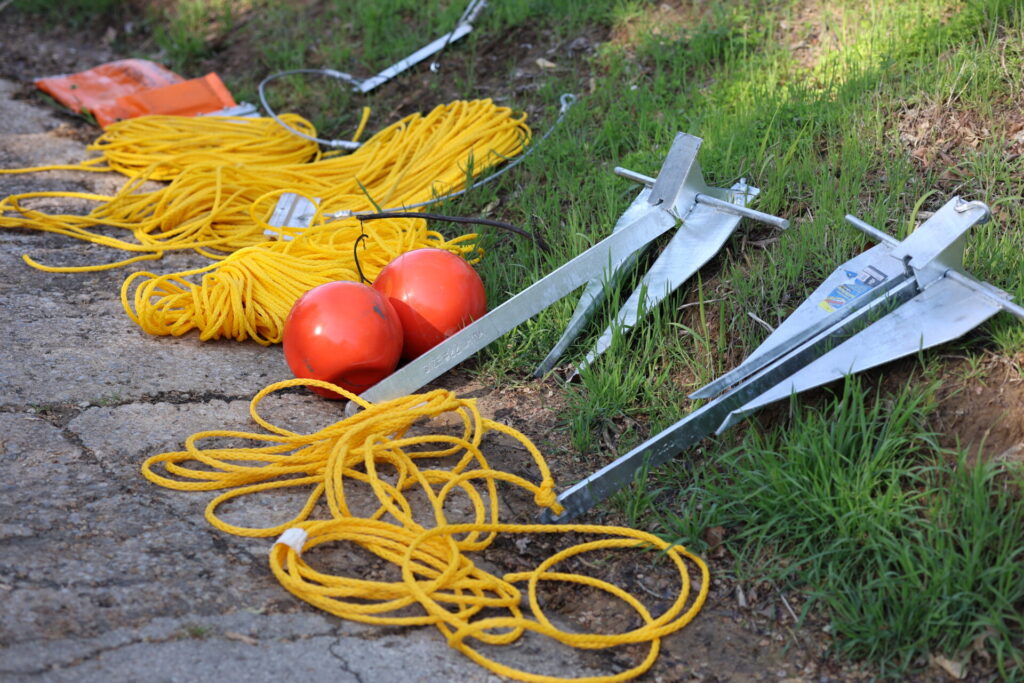 Preparing midstream anchor systems for containment boom deployment