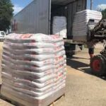 Pallets of Spill Tackle being loaded onto a truck for shipment