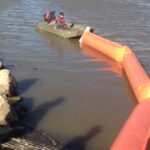A picture of ACME employees deploying Inflatable Boom