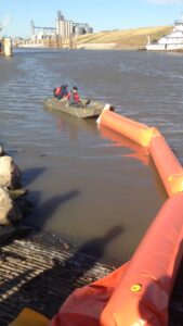 ACME employees deploying Inflatable Boom