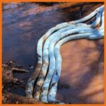 Absorbent boom deployed to prevent further spread of oil in creek